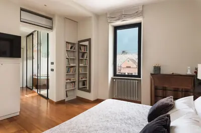 a bedroom with a bed and a large window at Idyllia - Penthouse in Navona Area in Rome
