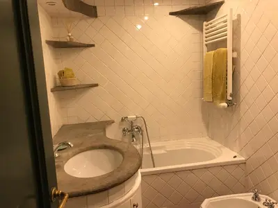 a bathroom with a sink and a bath tub at spacious apartment in the centre of Rome in Rome