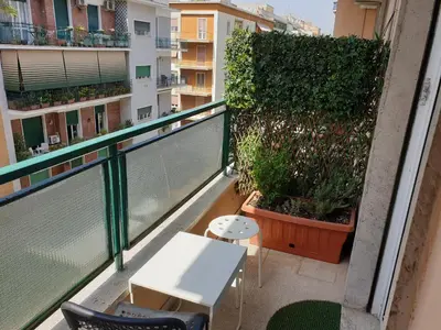 a bedroom with a bed with red curtains and a television at Holiday Max in Rome