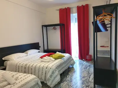 a bedroom with a bed with a yellow headboard at Holiday Max in Rome