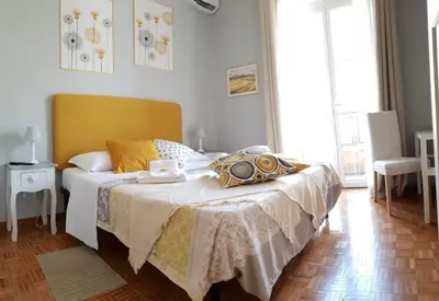 a bed with a pillow and two pictures on the wall at Holiday Max in Rome
