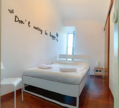 a bedroom with a bed with a sign on the wall at Colosseo Boutique Apartment in Rome