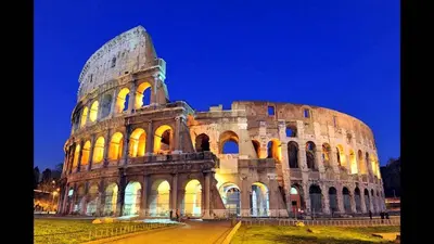 a large building that is lit up at night at Colosseo Boutique Apartment in Rome