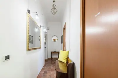 a hallway with a yellow pillow next to a door at St.Peter flat in Rome
