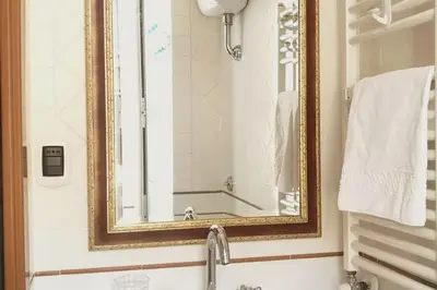 a bathroom with a mirror and a sink at St.Peter flat in Rome
