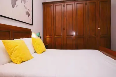 a bedroom with a bed with two yellow pillows at St.Peter flat in Rome