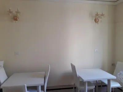 two white tables and chairs in a room at AFFITTACAMERE ROMANSTYLE in Rome