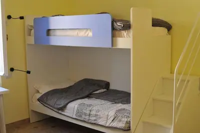 a bunk bed in a yellow room with a bedvisor at AFFITTACAMERE ROMANSTYLE in Rome