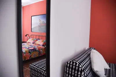 a mirror in a room with a bed and a couch at Vatican Mirò Holidays in Rome