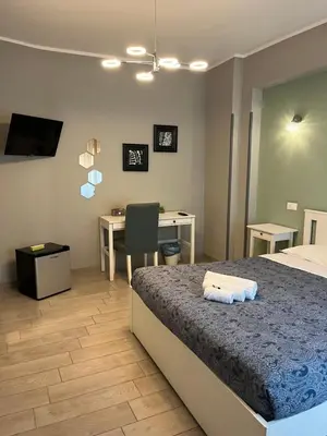 a bedroom with a bed and a desk with a computer at Pretty Tiburtina Room in Rome