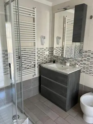 a bathroom with a sink and a shower and a toilet at Pretty Tiburtina Room in Rome