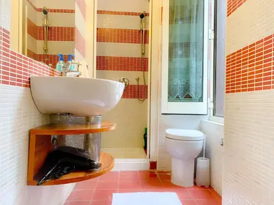 a bathroom with a sink and a toilet at Luxury barberini boutique Apartment in Rome
