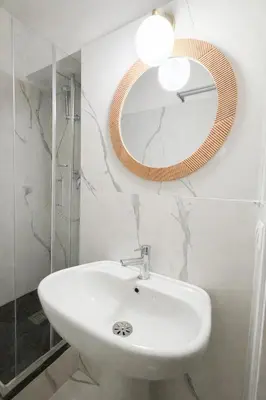 a bathroom with a sink and a mirror on the wall at Pied a Terre Barberini in Rome