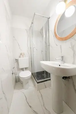 a bathroom with a sink and a toilet and a mirror at Pied a Terre Barberini in Rome