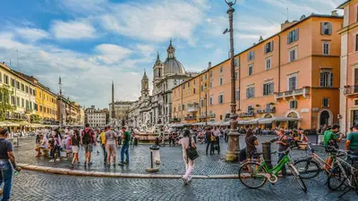 a group of people walking around in a street at Pied a Terre Barberini in Rome