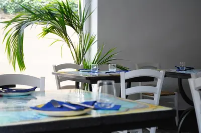 a dining room with tables and chairs with blue dishes at Il Faro Gianicolense in Rome