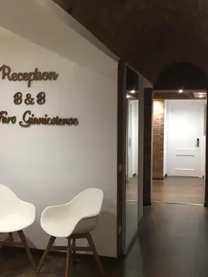a meeting room with two chairs and a sign on the wall at Il Faro Gianicolense in Rome
