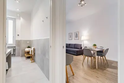 a living room with a table and a couch at Germanico Luxury Apartment in Rome