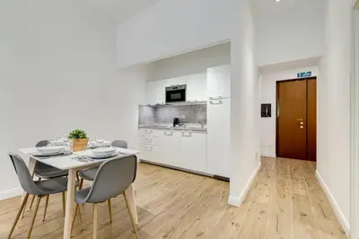 a kitchen and dining room with a table and chairs at Germanico Luxury Apartment in Rome