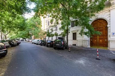 a street with cars parked in front of a building at Germanico Luxury Apartment in Rome