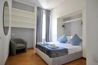 a bedroom with a bed with a chair and a window at Loft 5c - Palatino in Rome