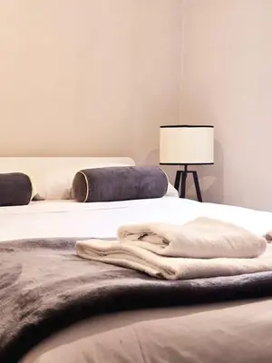 a bed with a blanket and a lamp in a room at Loft 5c - Palatino in Rome