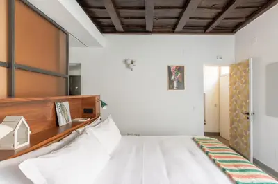 a bedroom with a bed with a wooden headboard at Monti Exclusive Medieval Tower in Rome