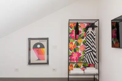 a room with two mirrors and some clothes at Monti Exclusive Medieval Tower in Rome