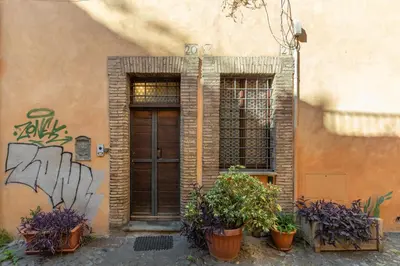 a building with a door and two potted plants at Monti Exclusive Medieval Tower in Rome