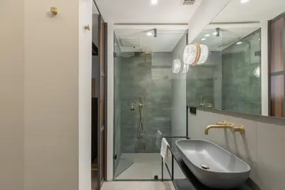 a bathroom with a sink and a shower at Monti Exclusive Medieval Tower in Rome