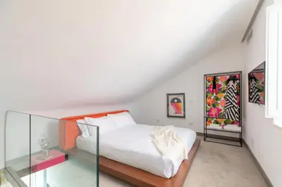 a bedroom with a white bed with a glass case at Monti Exclusive Medieval Tower in Rome