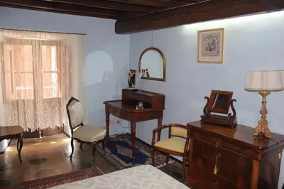 a bedroom with a desk and a table with a mirror at Penelope's House in Rome
