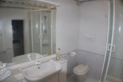 a bathroom with a toilet and a sink and a shower at Penelope's House in Rome