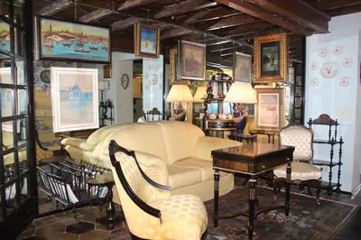 a living room with a couch and a table and chairs at Penelope's House in Rome