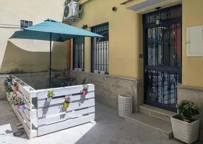 a patio with an umbrella and a table at Il Cortiletto di Via Tuscolana in Rome