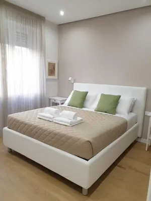 a bedroom with a large bed with two towels on it at T&T Luxury Home Rome int 4 in Rome