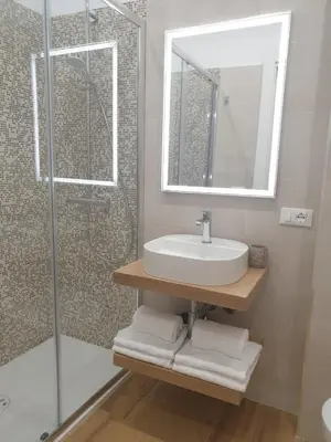 a bathroom with a sink and a shower with a mirror at T&T Luxury Home Rome int 4 in Rome