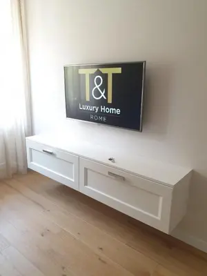 a white entertainment center with a tv on a wall at T&T Luxury Home Rome int 4 in Rome