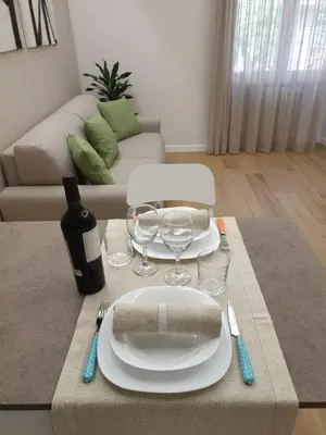 a table with a plate and wine glasses on it at T&T Luxury Home Rome int 4 in Rome