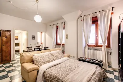 a living room with a bed and a couch at Popolo accommodation - Lovely Central apartment in Rome