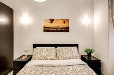 a bedroom with a bed and two night stands at Popolo accommodation - Lovely Central apartment in Rome