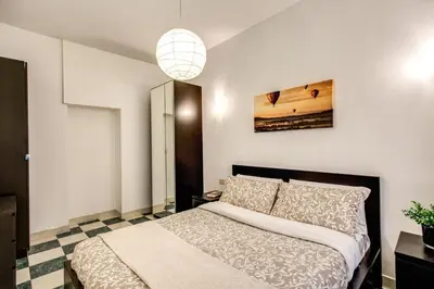 a bedroom with a bed and a pendant light at Popolo accommodation - Lovely Central apartment in Rome