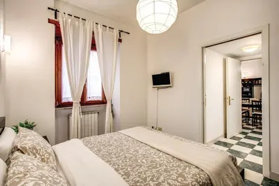 a bedroom with a bed and a window at Popolo accommodation - Lovely Central apartment in Rome