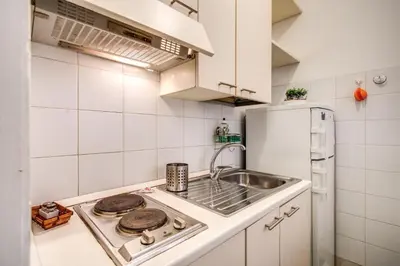 a small kitchen with a sink and a stove at Popolo accommodation - Lovely Central apartment in Rome