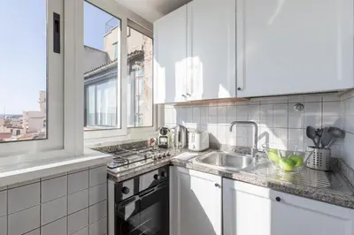 a kitchen with white cabinets and a sink at The Great View in Rome