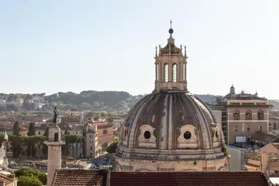 a building with a tower on top of a city at The Great View in Rome