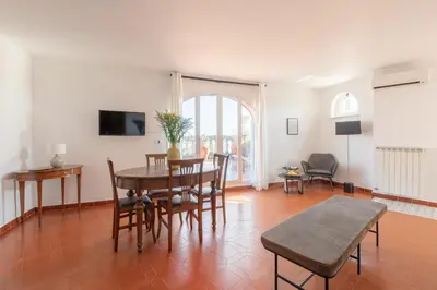 a living room with a table and chairs at The Great View in Rome