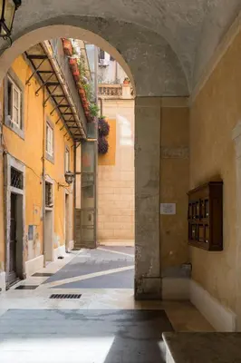 an alley with an archway in a building at A World Aparts - 13 T.Argentina in Rome