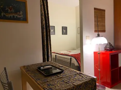 a room with a table with a mirror and a bed at Suite China Soul - Flaminio - Olimpico - Auditorium in Rome