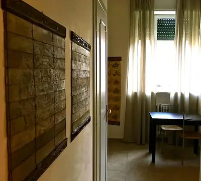 a room with a table and a window and a door at Suite China Soul - Flaminio - Olimpico - Auditorium in Rome